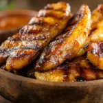 Crispy banana fries in a rustic bowl with dipping sauce